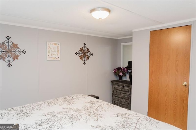 bedroom featuring ornamental molding and a closet