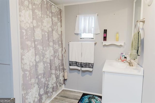 bathroom featuring vanity, curtained shower, and hardwood / wood-style flooring