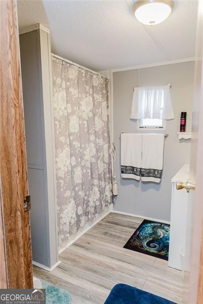 bathroom featuring hardwood / wood-style floors and curtained shower