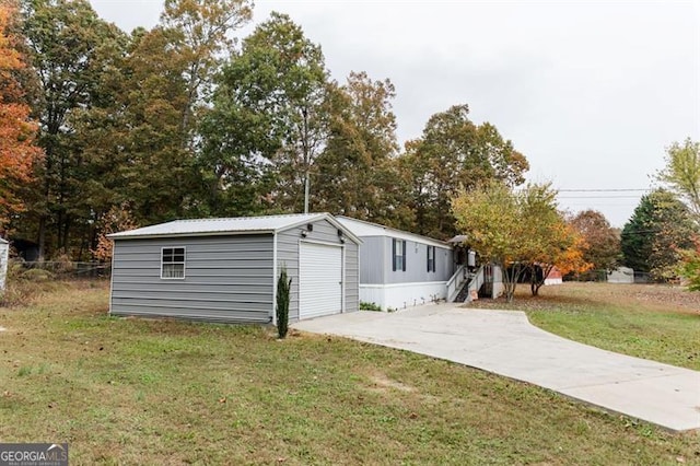 exterior space featuring a garage and a lawn