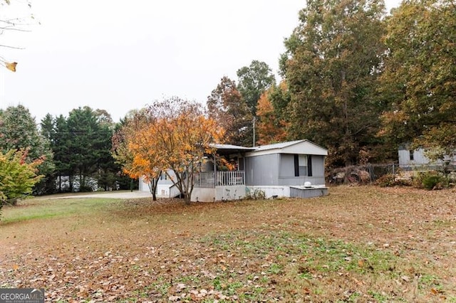 exterior space featuring covered porch, a lawn, and a garage