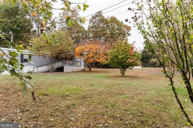 view of yard featuring a wooden deck