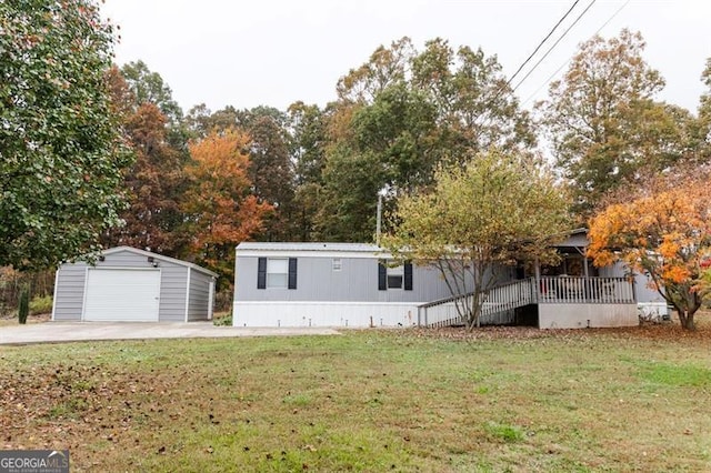 view of front facade with a front lawn and an outbuilding