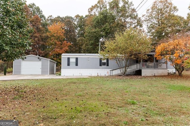 view of front of house with a garage, a front lawn, and an outdoor structure