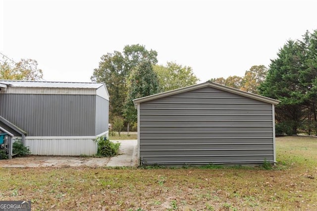 view of outbuilding with a yard