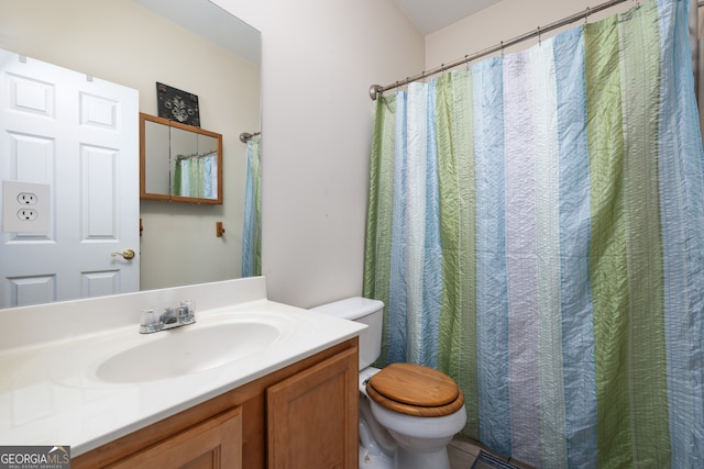 bathroom featuring vanity and toilet