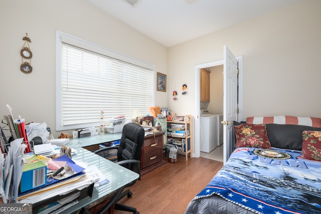 bedroom featuring washer and clothes dryer and hardwood / wood-style flooring