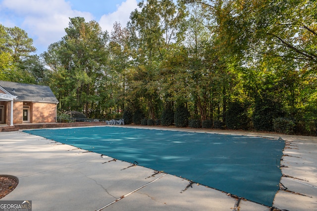 view of swimming pool with a patio area