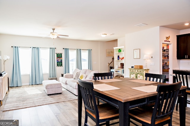 dining area featuring ceiling fan and light hardwood / wood-style flooring