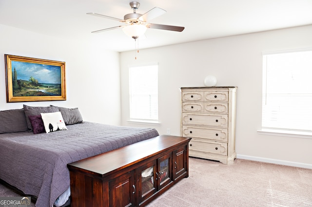 bedroom with ceiling fan and light colored carpet