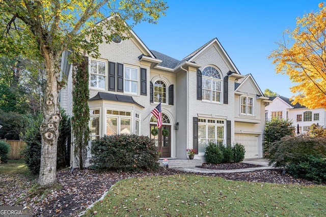 view of front of house featuring a garage and a front lawn