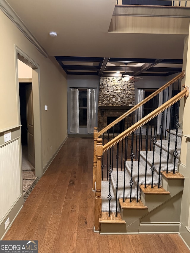 hall with crown molding, stairs, baseboards, and hardwood / wood-style floors