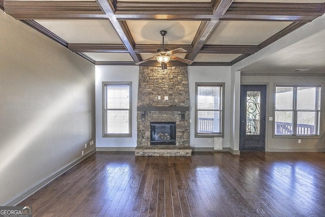 unfurnished living room with a wealth of natural light, wood-type flooring, a fireplace, and ceiling fan