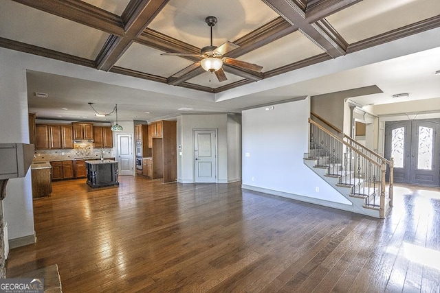 unfurnished living room featuring coffered ceiling, baseboards, stairs, french doors, and dark wood-style floors