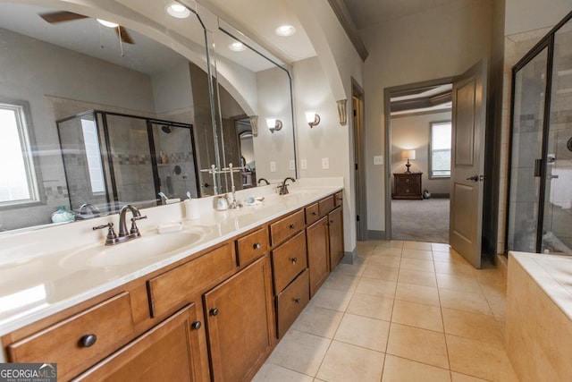 full bath featuring a stall shower, tile patterned flooring, and a sink