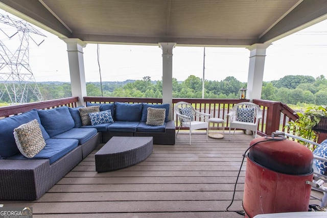 wooden terrace with grilling area and an outdoor hangout area