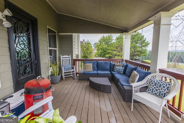 wooden terrace with an outdoor hangout area