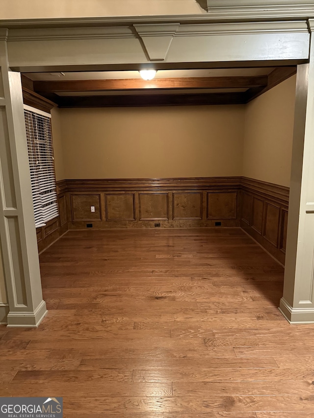 empty room featuring light wood-style floors and wainscoting