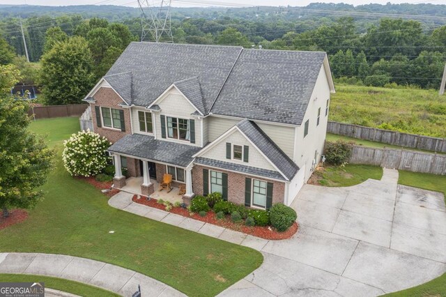 view of front of house featuring a porch and a front yard