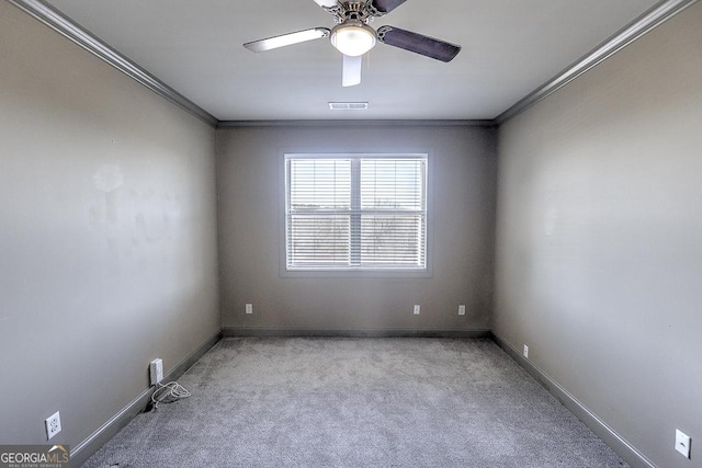 empty room with ornamental molding, carpet, and visible vents