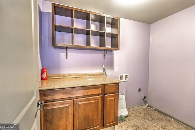 clothes washing area with hookup for a washing machine, cabinet space, and electric dryer hookup