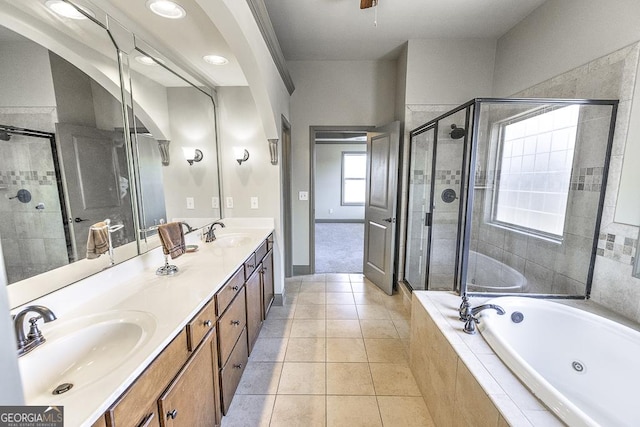 bathroom featuring a tub with jets, a sink, and a shower stall