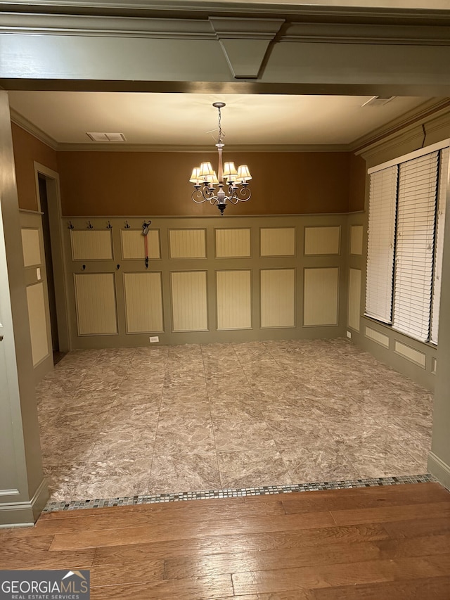 interior space featuring a chandelier, wood-type flooring, and ornamental molding