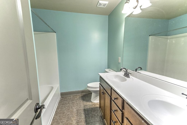 bathroom featuring toilet, a sink, visible vents, and baseboards