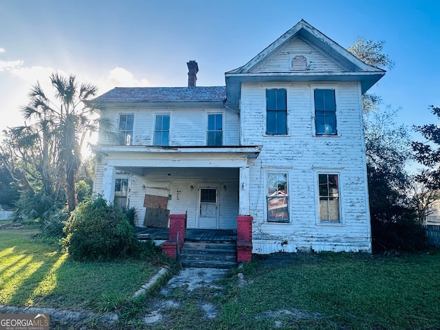 view of front of house with a porch and a front lawn