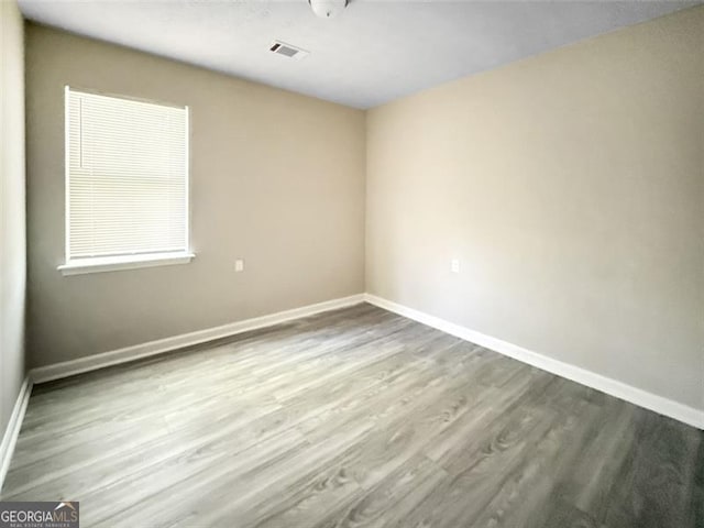 spare room featuring hardwood / wood-style flooring