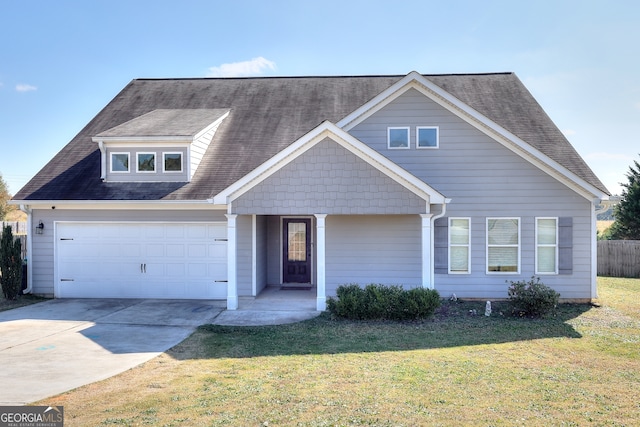 view of front of property featuring a garage and a front lawn