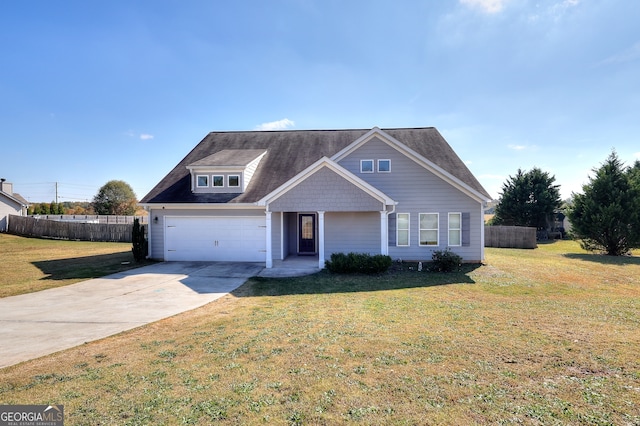 view of front of property featuring a front yard and a garage