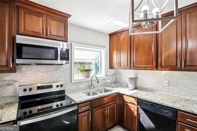 kitchen featuring light stone countertops, appliances with stainless steel finishes, sink, decorative backsplash, and an inviting chandelier