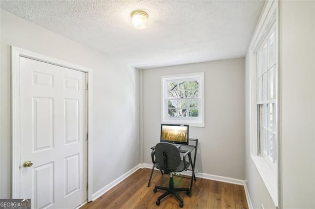 office space with a textured ceiling and dark hardwood / wood-style floors