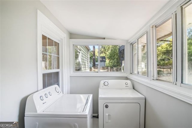 washroom featuring washing machine and clothes dryer and a wealth of natural light