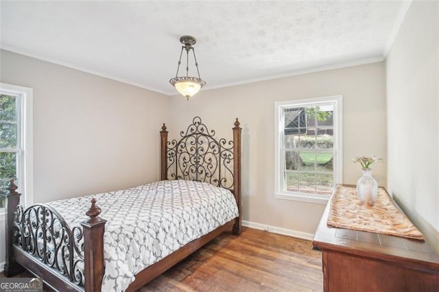 bedroom featuring crown molding and dark hardwood / wood-style flooring