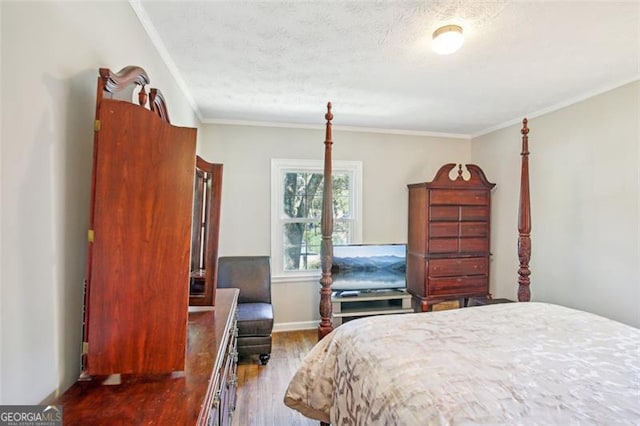 bedroom with dark wood-type flooring, crown molding, and a textured ceiling