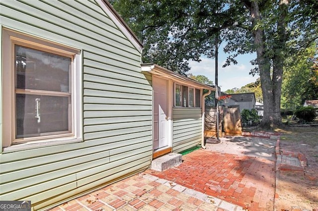 view of property exterior with a patio area