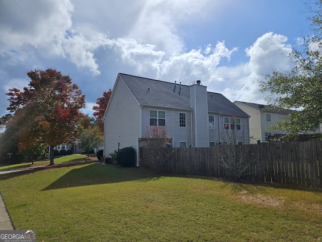 back of property featuring a lawn