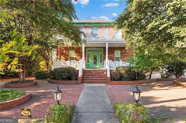 view of front of home featuring a porch and a balcony