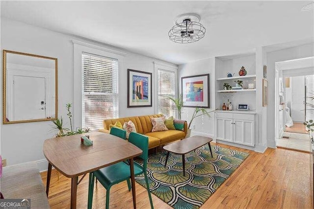 living room with light hardwood / wood-style floors and ceiling fan