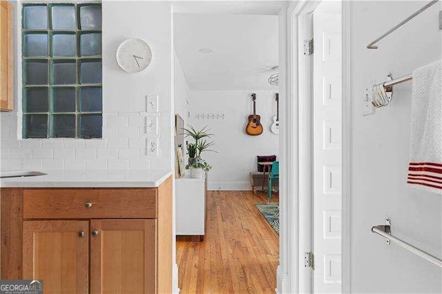 bathroom with backsplash and hardwood / wood-style floors