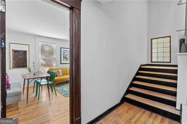 stairs with hardwood / wood-style floors