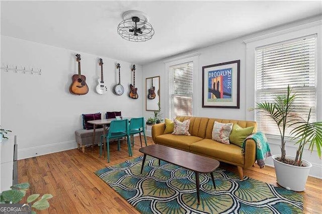 living room with wood-type flooring and ceiling fan