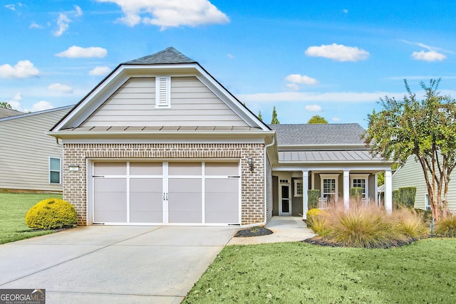 view of front of home with brick siding, concrete driveway, a standing seam roof, metal roof, and a garage