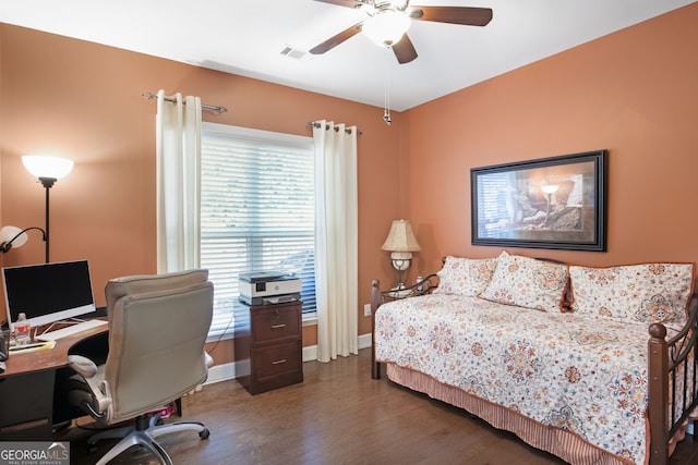 bedroom with ceiling fan, wood finished floors, visible vents, and baseboards