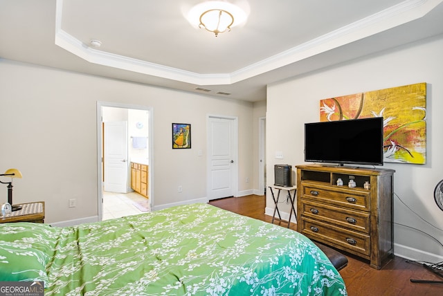 bedroom featuring ornamental molding, a tray ceiling, and baseboards