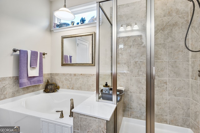 full bath featuring a stall shower and a garden tub