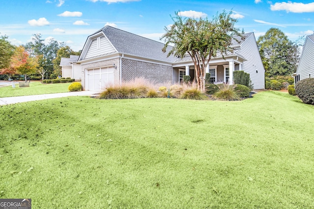 view of front facade with brick siding, a shingled roof, an attached garage, driveway, and a front lawn