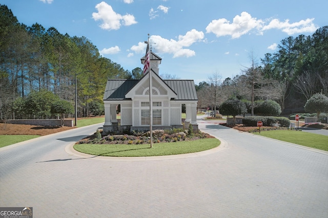 view of building exterior with curved driveway